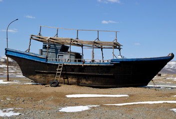 Naklejka na meble Abandoned North Korean fishing schooner on the shore of the Sea of ​​Japan, Primorye, Russia.