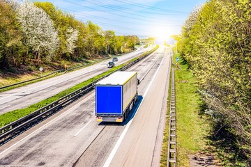 Truck moves on the road at speed, delivery of goods.