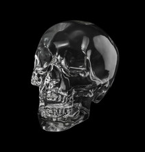 Close-up Of Crystal Skull Over Black Background