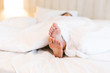 © Gengwit - Close up of foot in bed. Moring concept