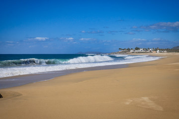 Surf side view of waves crashing on the beach.