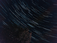 Low Angle View Of Star Trails In Sky At Night