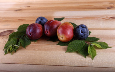 Sticker - Different color plums on table