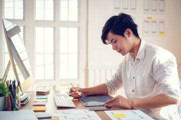 Wall Mural - young asian man designer planning develop application develop for mobile phone at home.