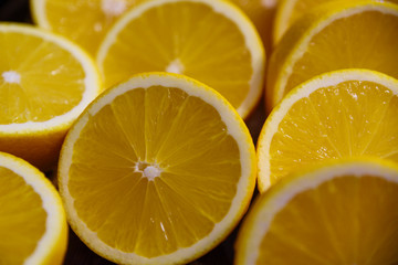 Sliced yellow juicy lemons background