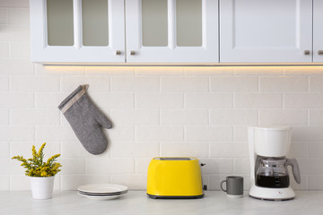 Sticker - Modern toaster, coffeemaker and dishware on counter in kitchen