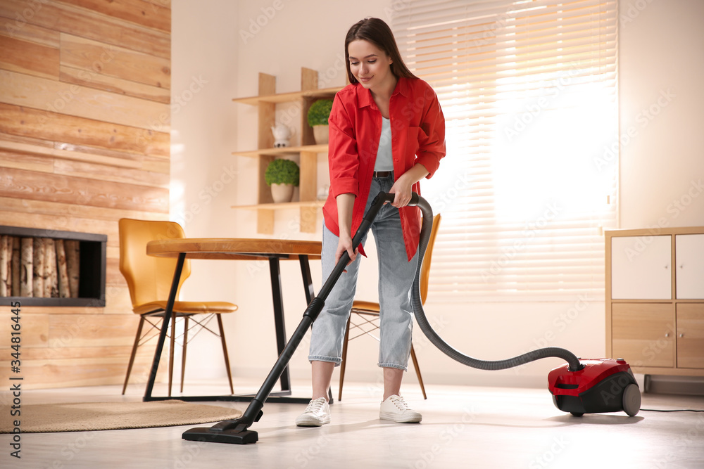 مكنسة البا الكهربائية 2000 وات - أحمر TURBO2400D Young woman using vacuum cleaner at home Stock Photo | Adobe Stock