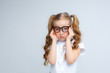 © Olesya Pogosskaya - little girl in school uniform and glasses upset on a white background