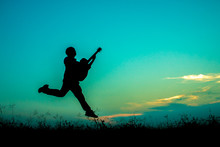 Silhouette Of Man Playing Guitar Against Sky