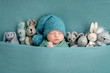 © tan4ikk - Beautiful newborn with knitted toys