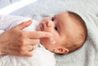 Baby with atopic dermatitis getting cream put. Care and Prevention Of Eczema.