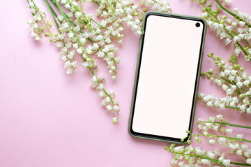 Wall Mural - phone mockup with flower, blossom, flat lay, top view digital invitation with lily of the valley