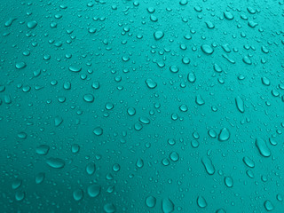  Drops of water on a turquoise metal surface, beautiful background after rain