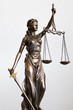 statue of Justitia with blindfold, sword and balance on white background