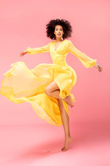 Sticker - Afro girl dancing in yellow maxi dress.