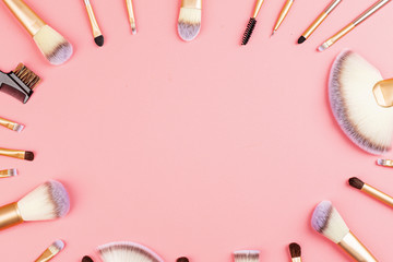 Wall Mural - Cosmetic Makeup brushes on pink background. Flat lay, top view, copy space. Makeup accessories, mockup, template