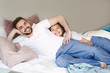 © elemakar - Young couple in love is lying on the bed and  laugh