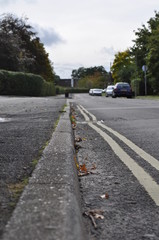 Double yellow lines at the edge of a British Road.