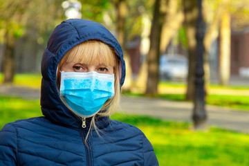 Wall Mural - Young woman in protective mask on the park in the city with air pollution