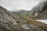 Fototapeta Góry - The Washington Section of the Pacific Crest Trail in the North Cascades with view of cloud covered rocky mountains and snow.