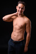 © Ranta Images - Young handsome multi ethnic man shirtless against black background