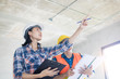 © khwanchai - Team of Inspector holding clipboard opening paper and checking building for renovation, engineer surveyor looking in construction site. Home inspection consultancy concept