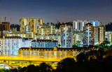 Fototapeta Las - Apartment buildings at night in Singapore
