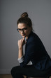 © arthurhidden - Portrait of a beautiful young business woman standing against grey wall