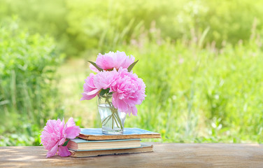 Wall Mural - pink peony Flowers and books in summer garden. blossom season,  romantic composition. copy space