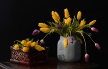 Beautiful Bouquet Of Yellow And Purple Tulips In A Grey Vase On The Brown Table