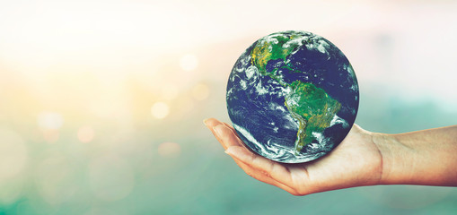 woman hands holding global over blurred nature backgrounds, concept of love the world.elements of th