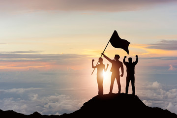 silhouette of victory business team on mountain with sunset and sky background. business teamwork su