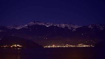 Wall Mural - Night view of the Klewenalp mountains and Lake Lucerne. Starry sky. Switzerland.