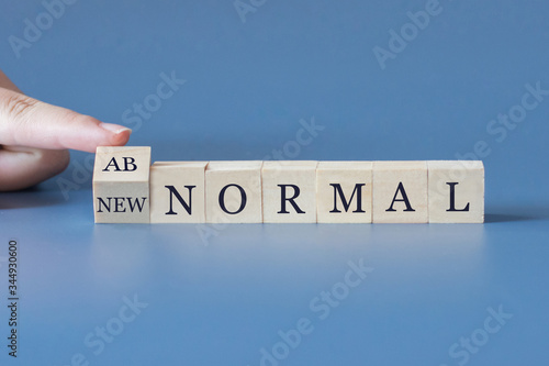 The word of new normal and abnormal with human's finger.Concept of new normal behavior after Coronavirus Covid-19 concept.