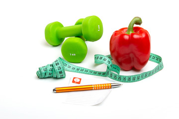 Wall Mural - Measuring tape, bright red, pepper with green dumbbells, writing paper and yellow pen on white background