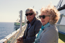 Seniors Standing Outside On The Deck Of A Cruise Ship