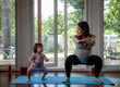 © Jovo Jovanovic/Stocksy - Mom and daughter exercising together at home