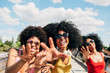 © MyMicrostock/Stocksy - Afro women friends hanging out in the city