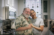 © Joselito Briones/Stocksy - Portrait of Loving Senior Gay Couple in their Kitchen