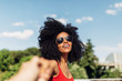 © MyMicrostock/Stocksy - Afro woman hanging out in the city taking friends hand
