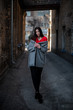 © prokop.photo - Girl in a red blouse and a gray cardigan on the background of the old brick wall