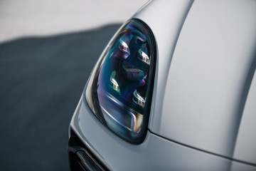 Sticker - Headlight of modern luxury supercar. Close up detail shot