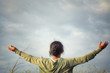 © Maria Marganingsih - Happy young woman with arms outstretched against blue sky background. Grateful and freedom concept. Copy space for your text or design.