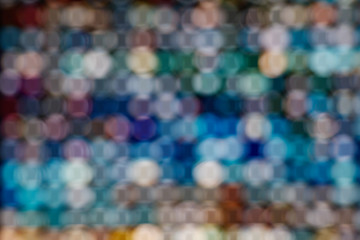 Wall Mural - Blurred colorful LED illuminated bokeh background on Grid frame arrangement system. Abstract defocused illuminated backdrop with light bokeh on rectangular grid pattern dispaly.
