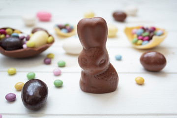 Canvas Print - Chocolate bunny and easter eggs and sweets on white wooden table