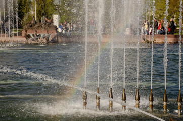 Rainbow in the jets of the fountain in the park