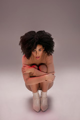 Wall Mural - Afro girl posing in studio.