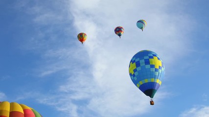 Wall Mural - Colorful hot air balloons in blue sky, 4k