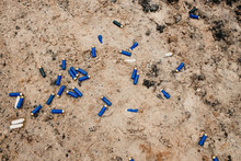 Used Ammunition Cartridges On A Soil. 12 Mm. Background