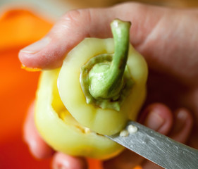 Cutting the top of the bell pepper.